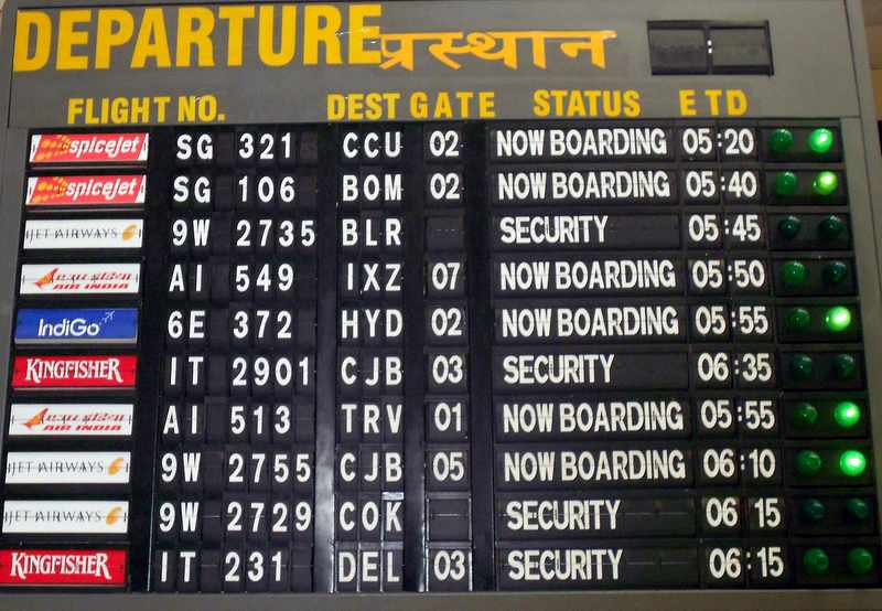 a close-up of a flight information board