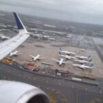 an airplane wing with many airplanes on the ground