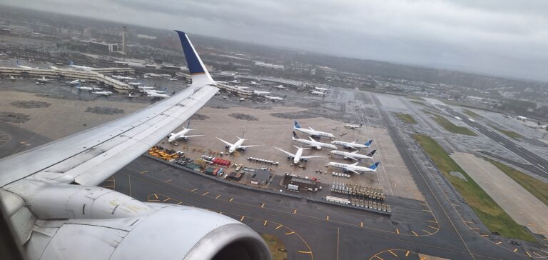 an airplane wing with many airplanes on the ground