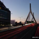 a bridge with a large tower and a building with lights