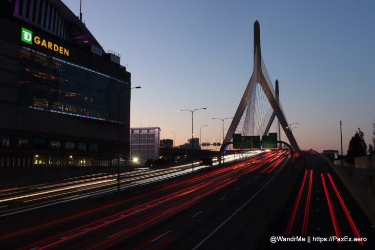 a bridge with a large tower and a building with lights