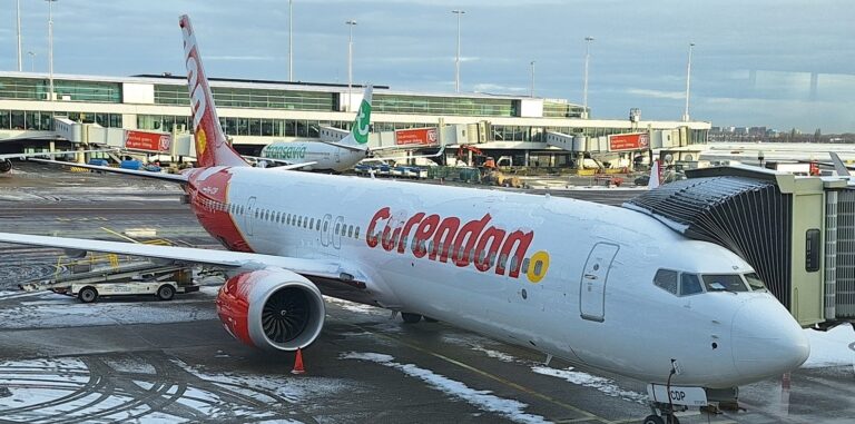 Corendon 737 MAX at a gate, partially covered with snow